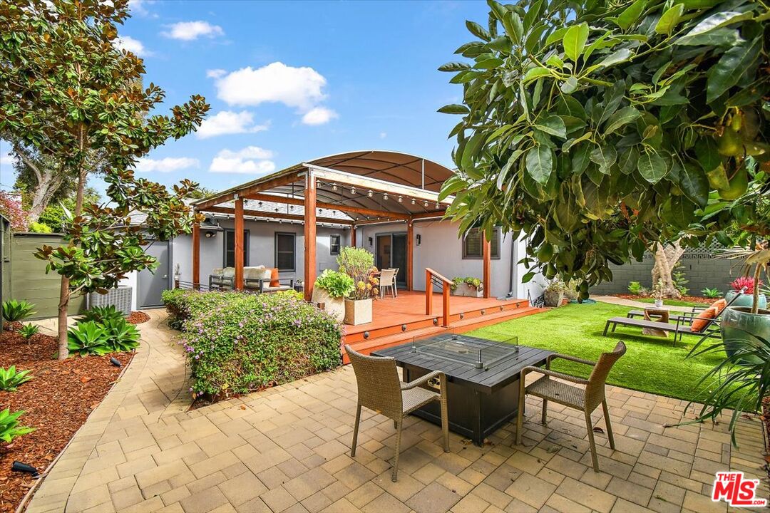 a view of a house with backyard and sitting area