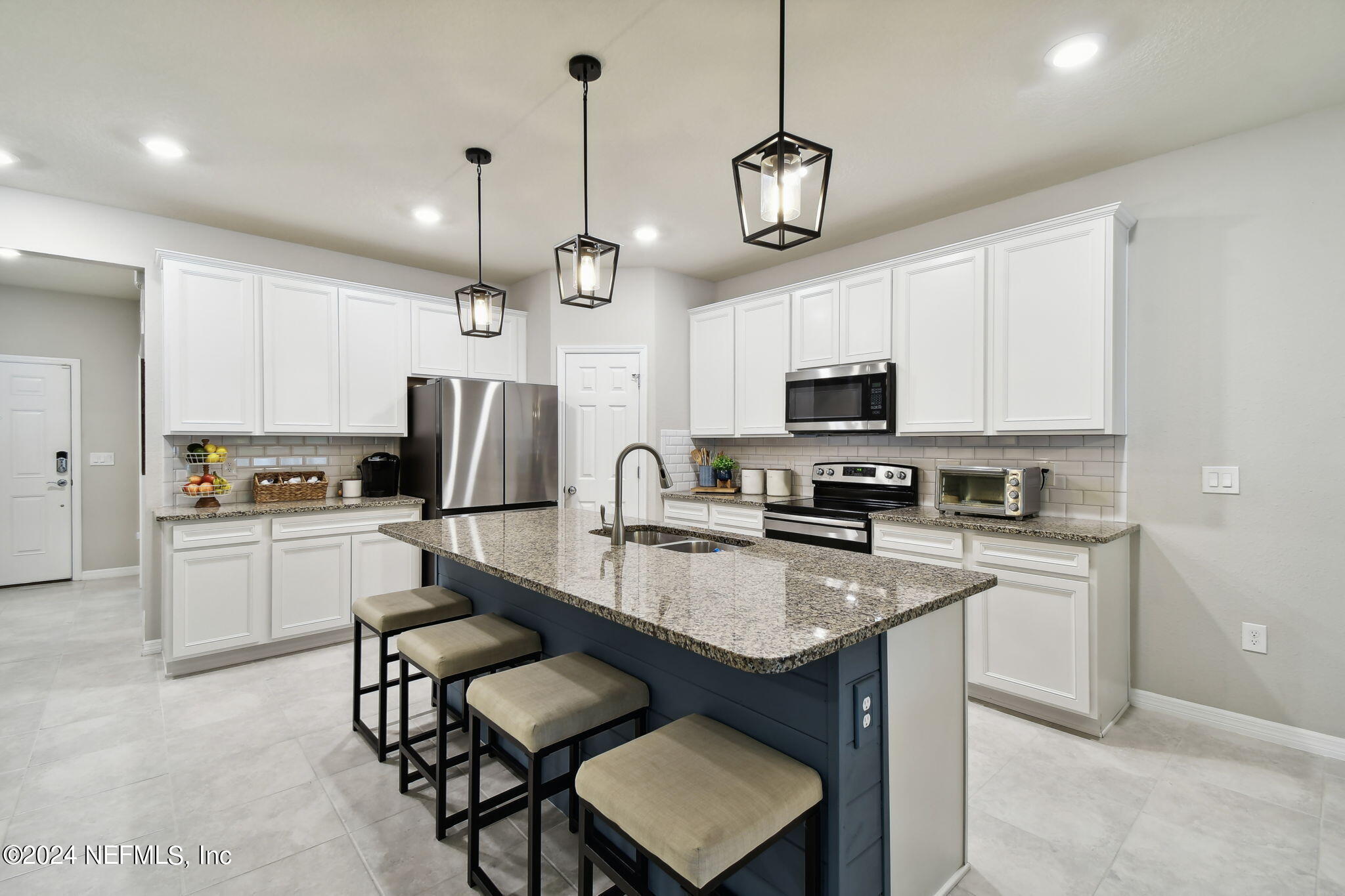 a kitchen with refrigerator cabinets and microwave