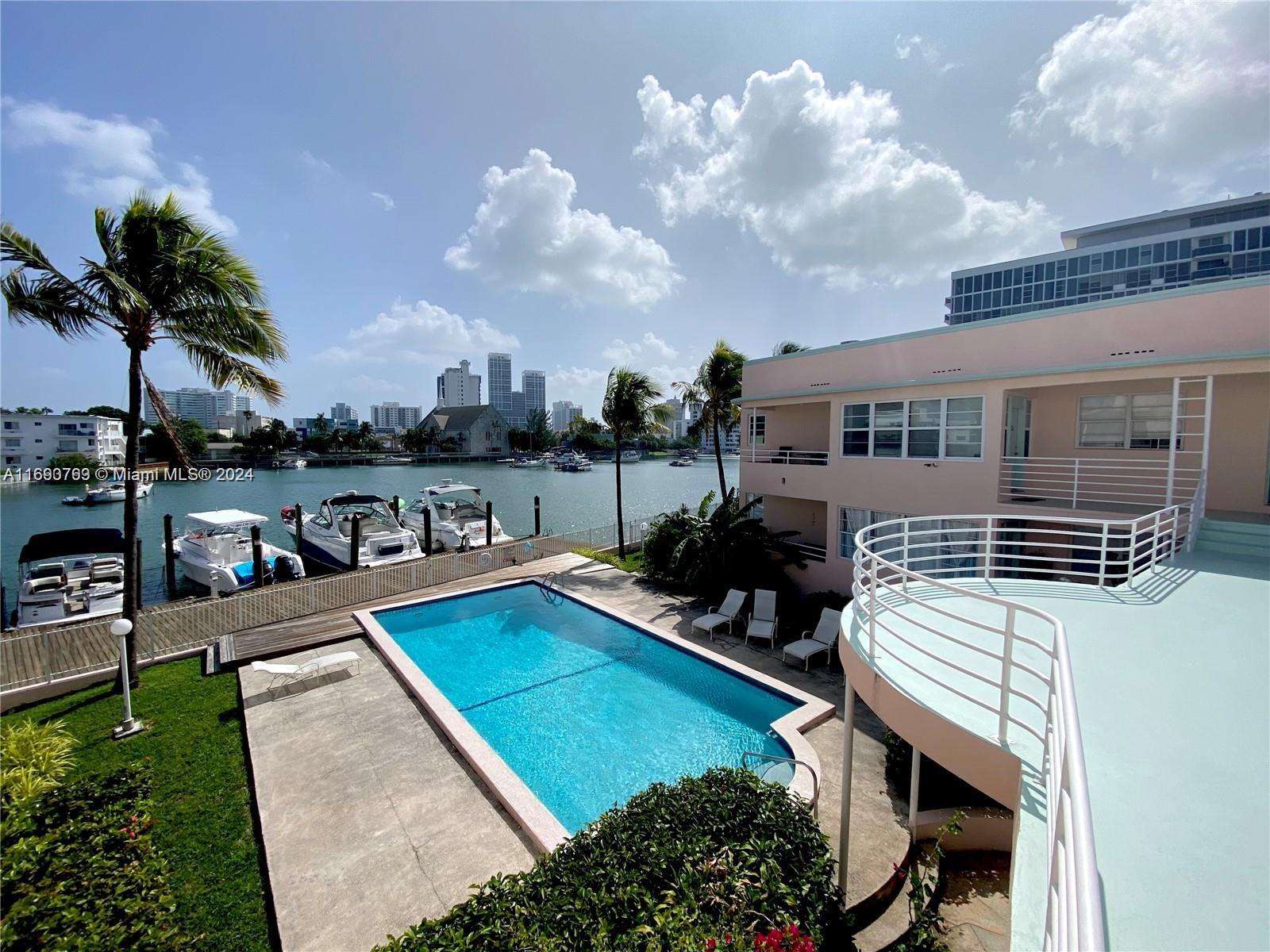 a view of a house with pool and chairs