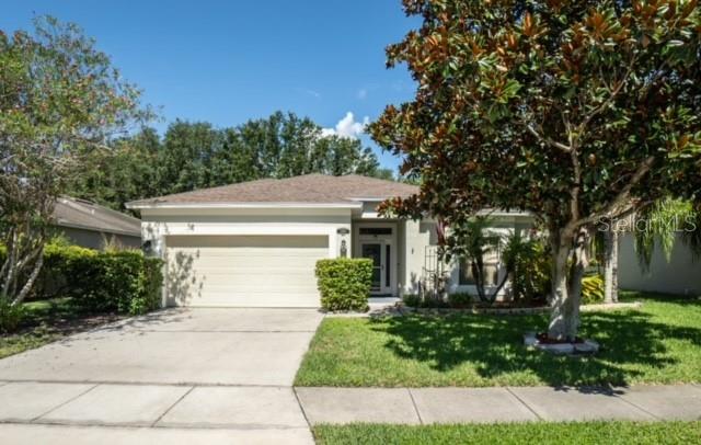 a front view of a house with a yard and a garage