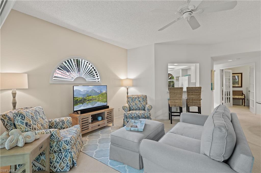 a living room with furniture and a lamp