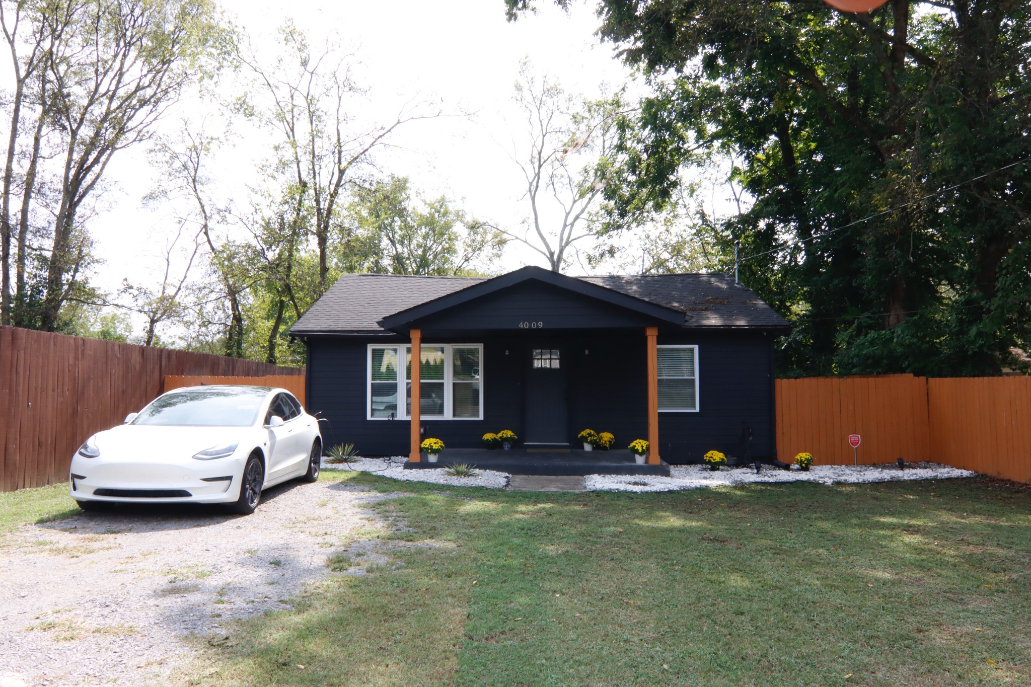 a view of a house with backyard space and porch