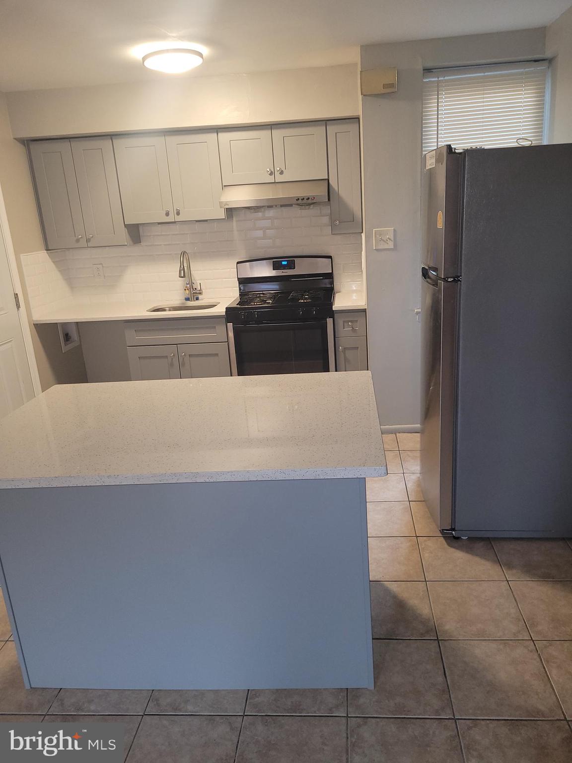 a kitchen with stainless steel appliances a refrigerator and a stove