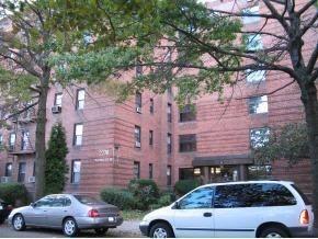 a view of cars parked in front of a brick house