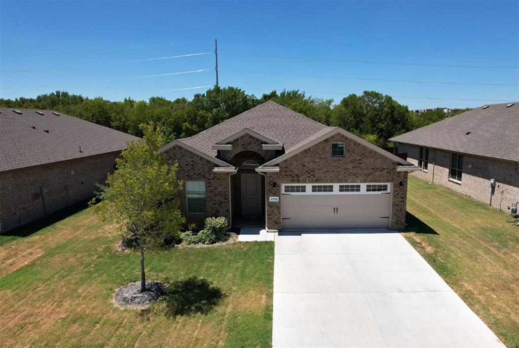 a aerial view of a house next to a yard