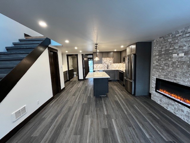 a view of a kitchen with wooden floor and electronic appliances