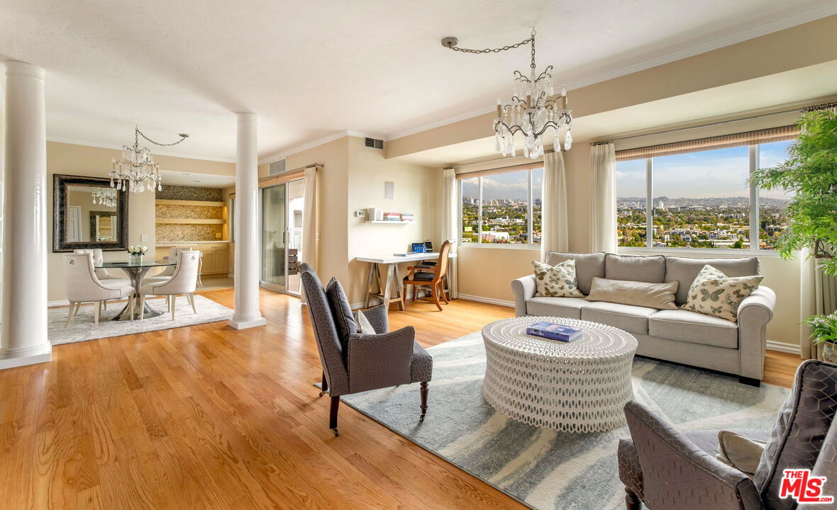 a living room with furniture and a chandelier