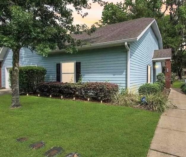 a front view of house with yard and green space