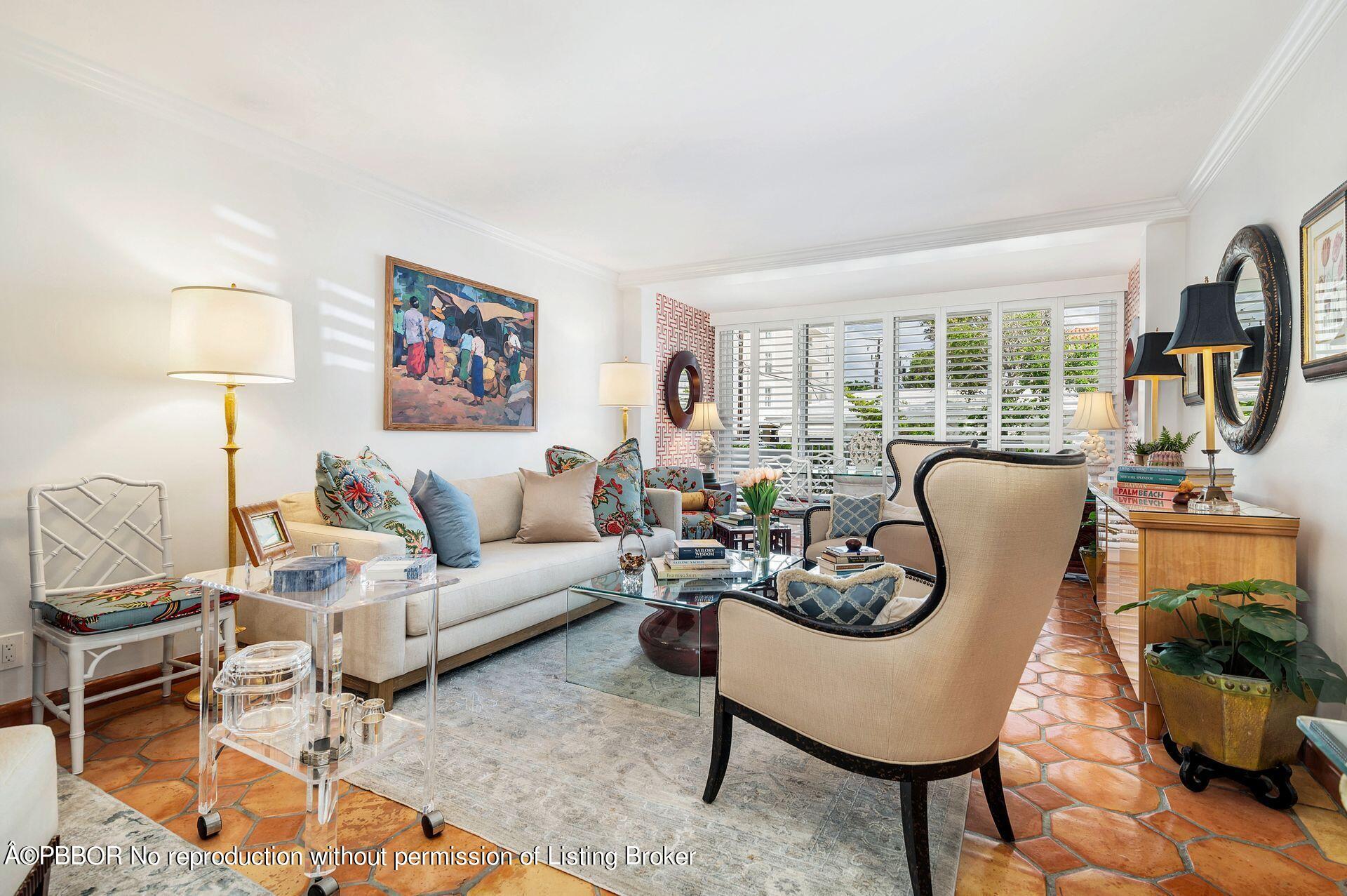 a living room with furniture fireplace and a large window