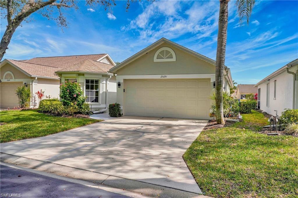 View of front of home with a front lawn and a garage