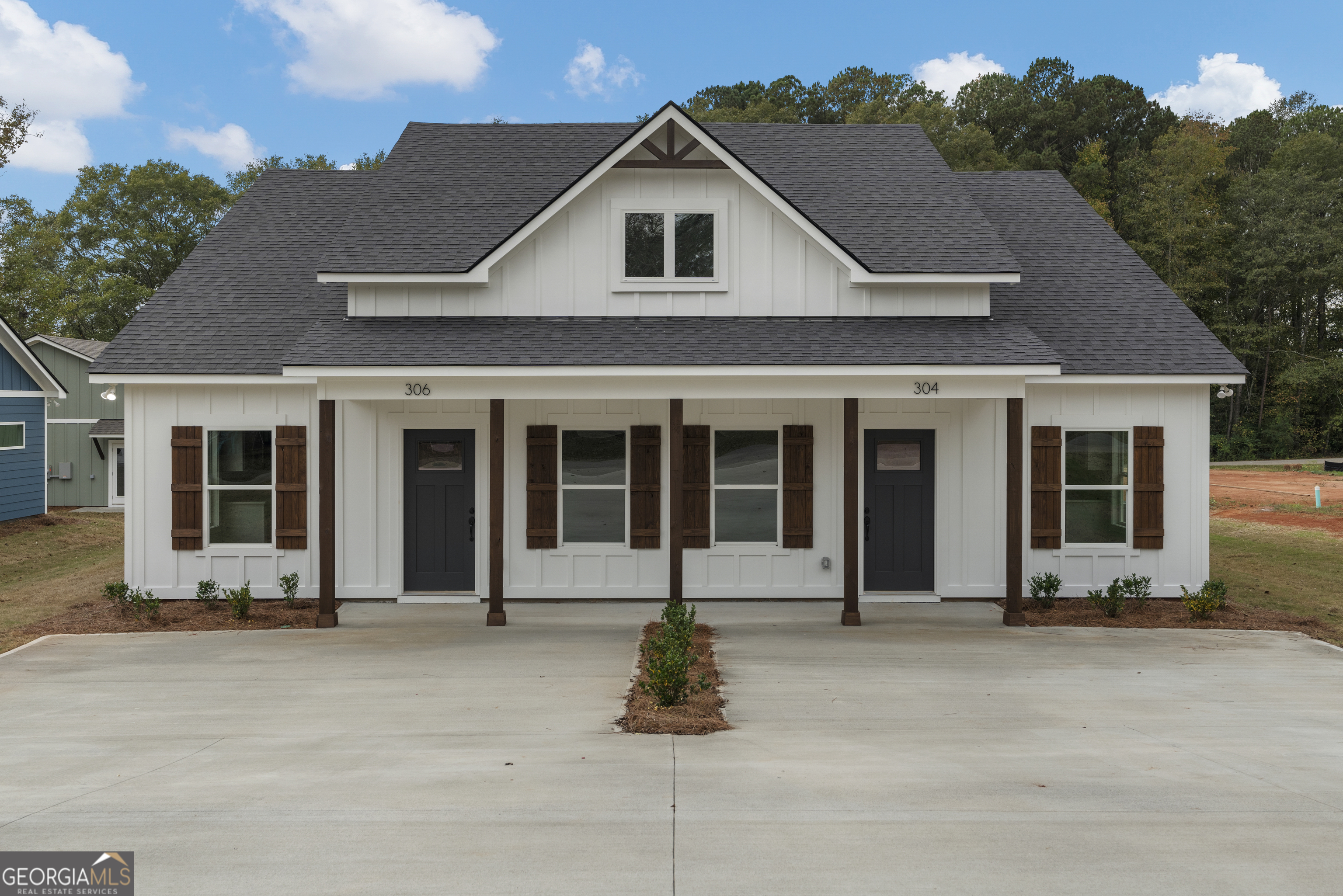 a front view of a house with a garden