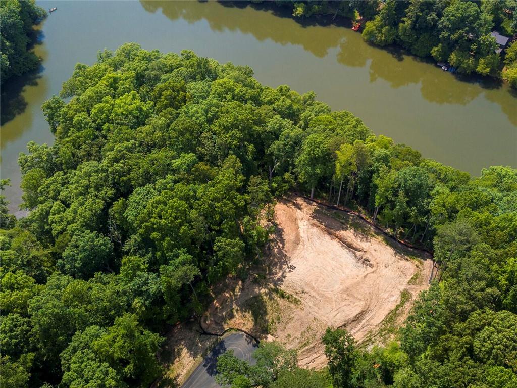 an aerial view of a house with a yard and lake view