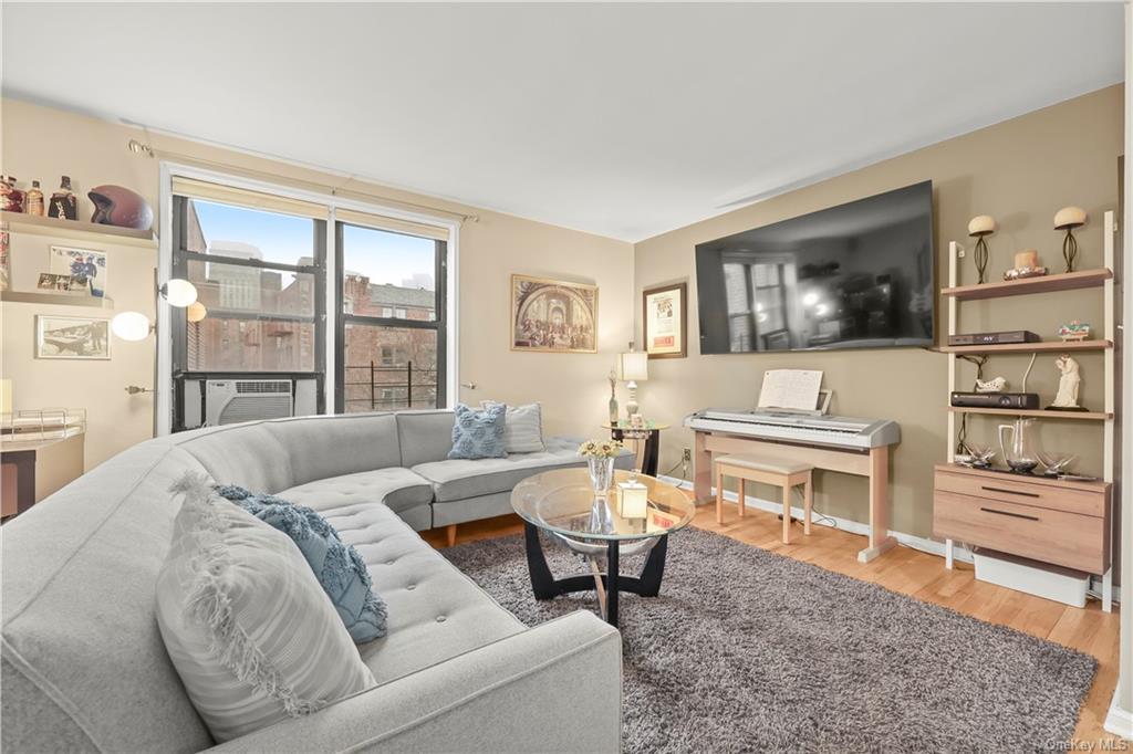 a living room with furniture a rug and a flat screen tv