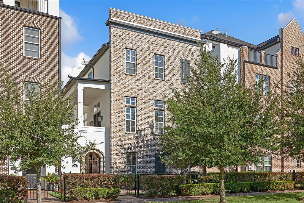 a front view of a residential apartment building with a yard