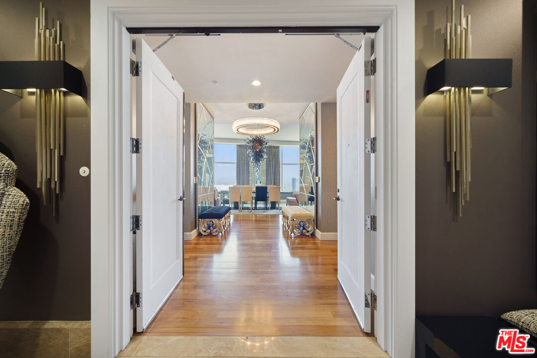 a view of a hallway with living room and couches