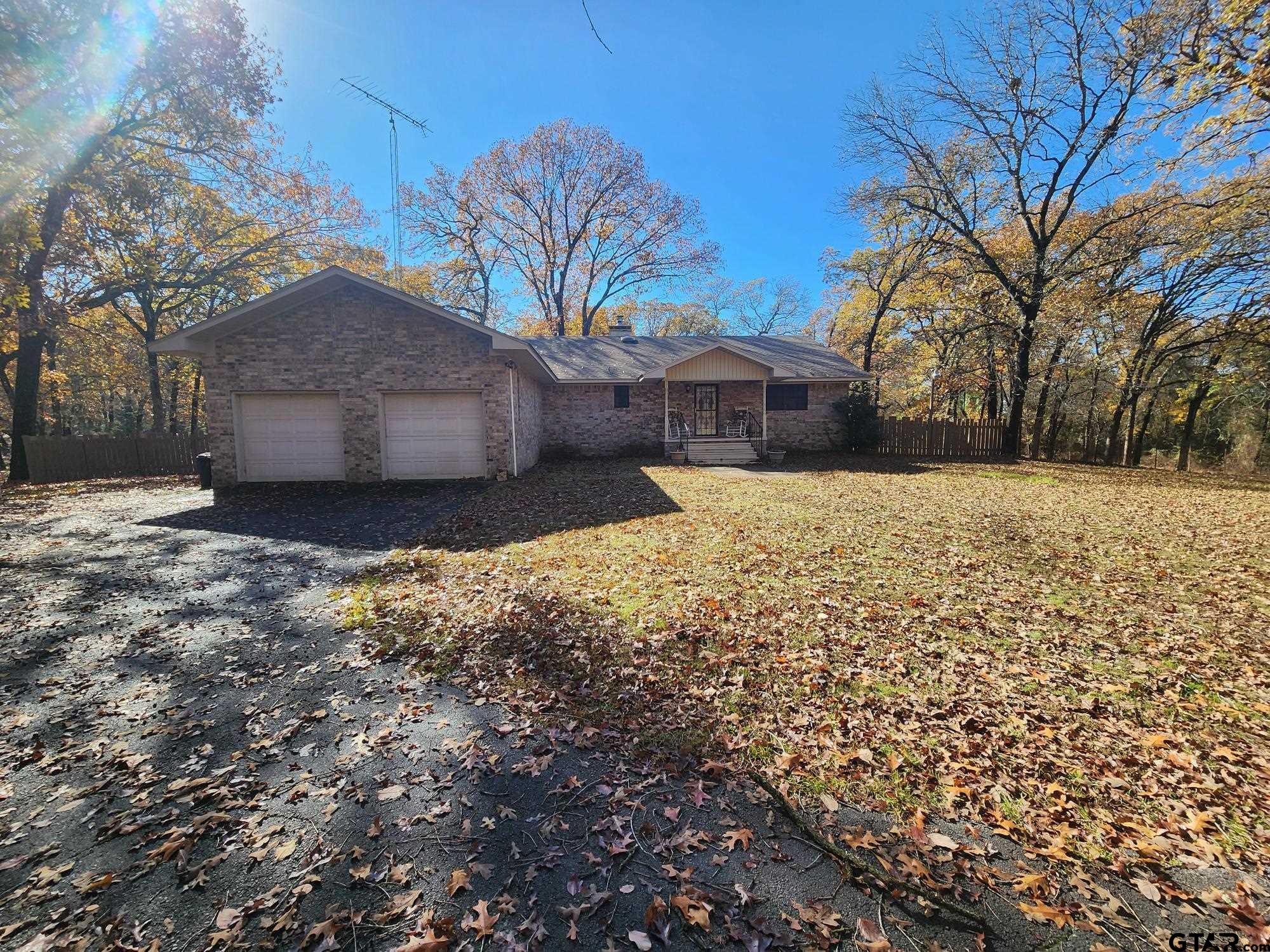 a front view of a house with a yard and covered with snow