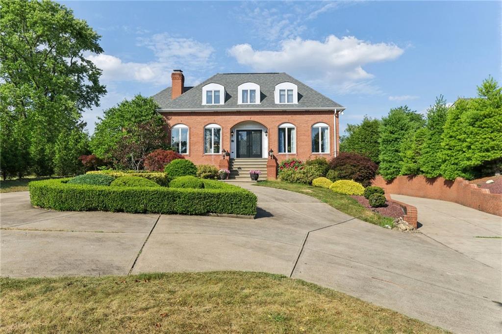 a front view of a house with a garden and pathway