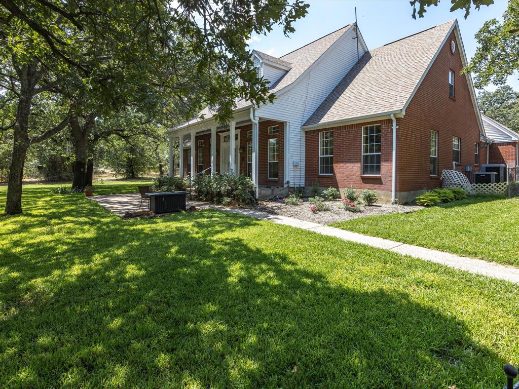 a front view of house with yard and green space