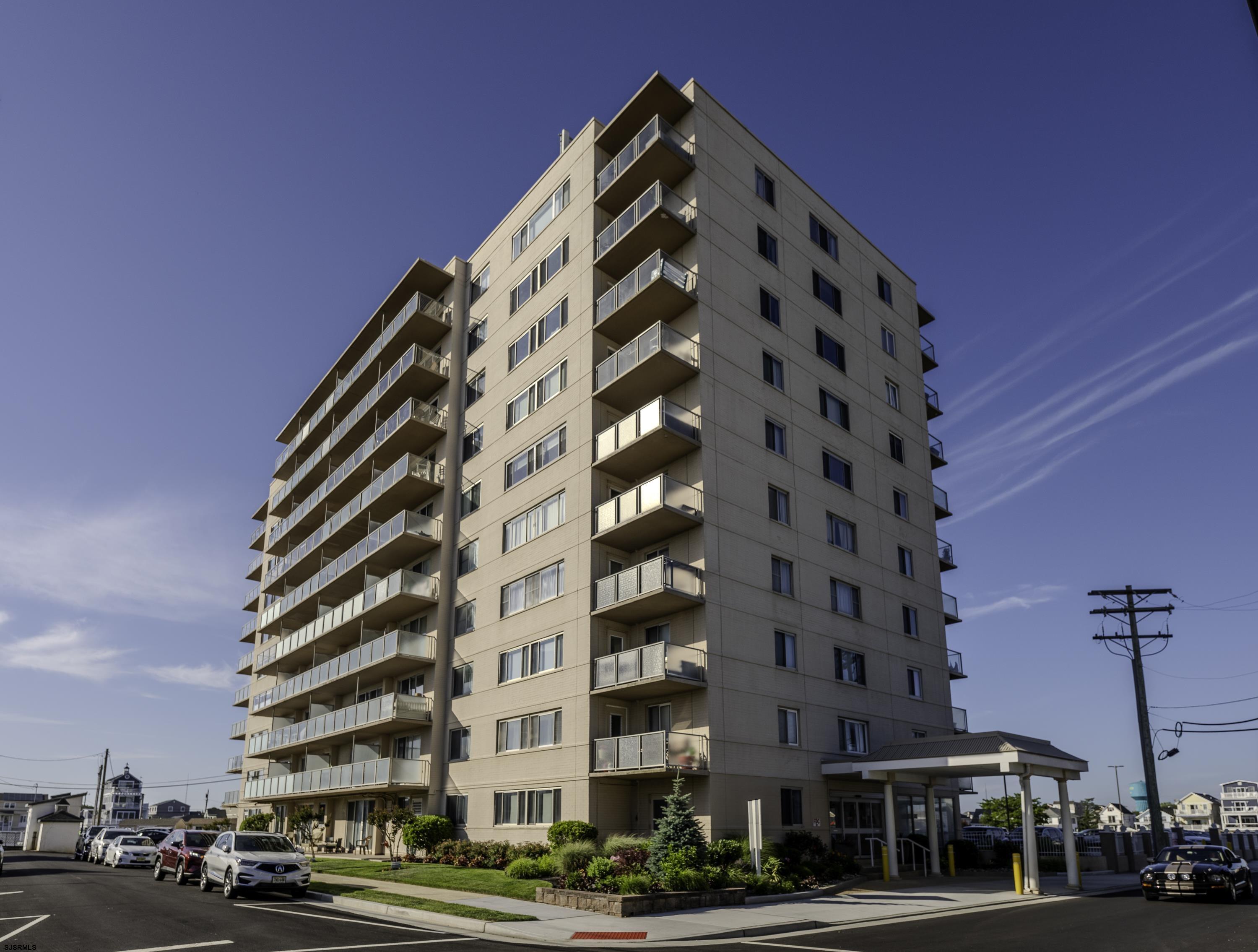 a view of a tall building next to a street