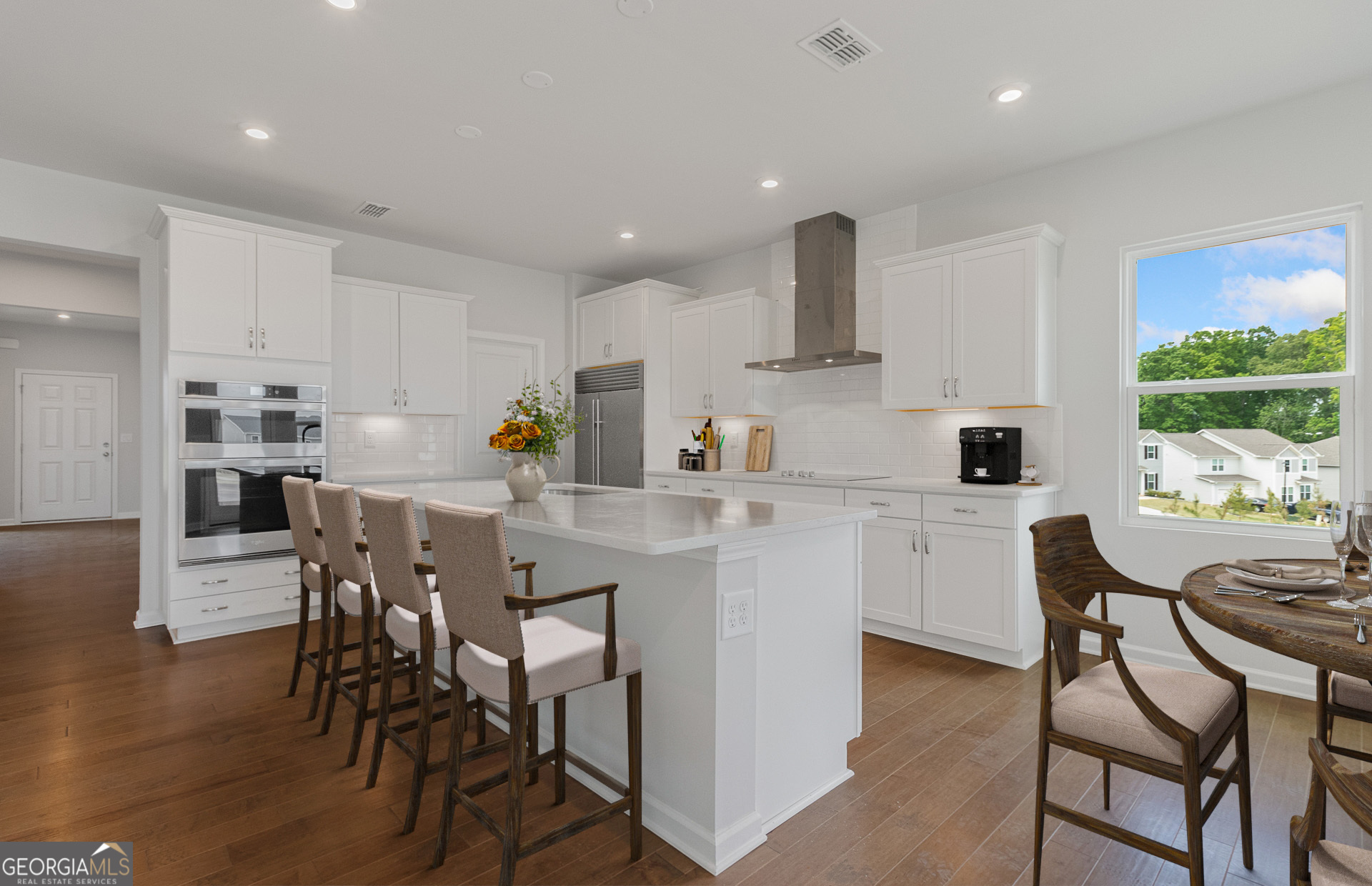 a kitchen with a table chairs refrigerator and cabinets