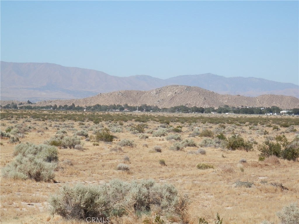 a view of mountain with lake in background