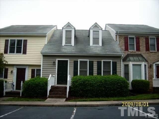 a front view of a residential apartment building with a yard