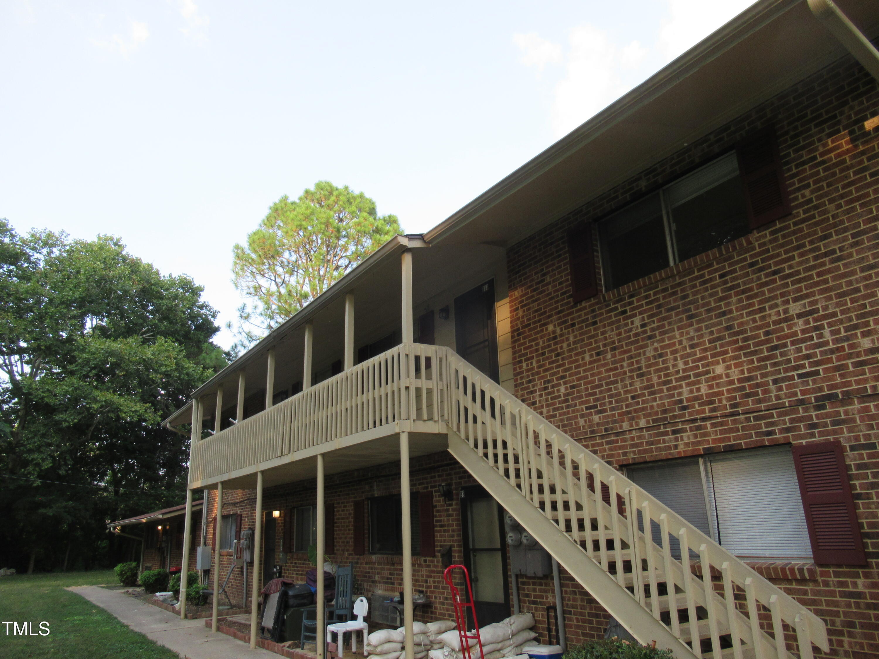 a front view of house along with deck and outdoor space