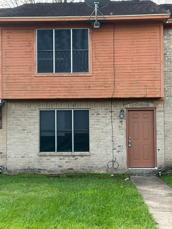 a view of a house with a window and a yard