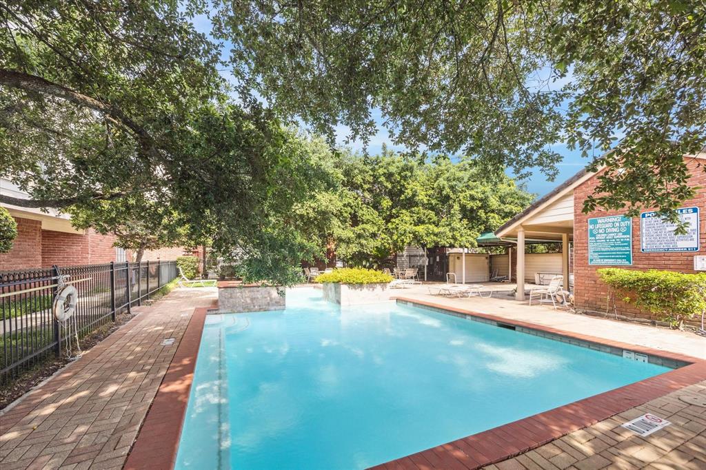 a view of a house with pool and chairs