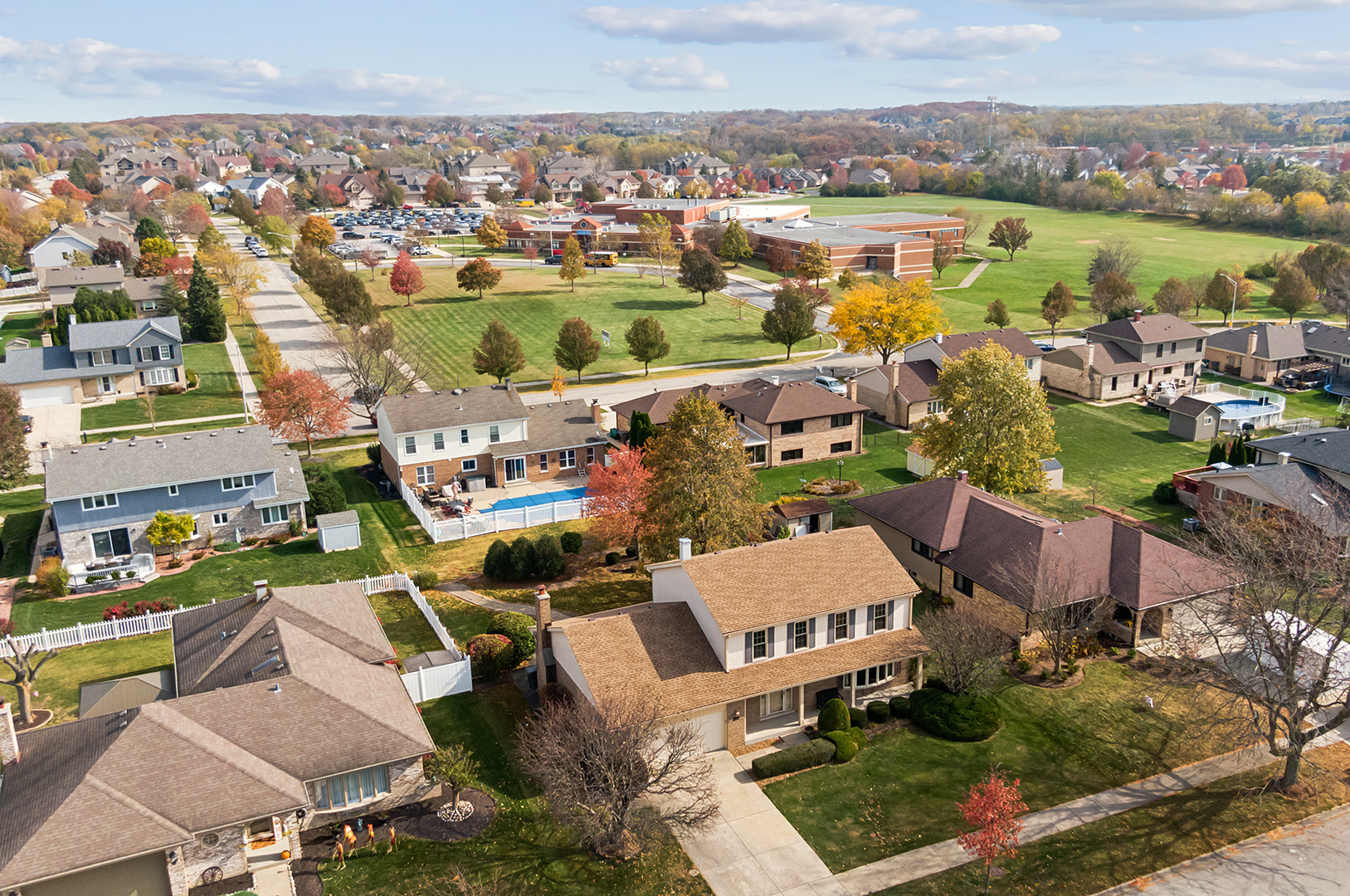 an aerial view of residential houses with outdoor space and river