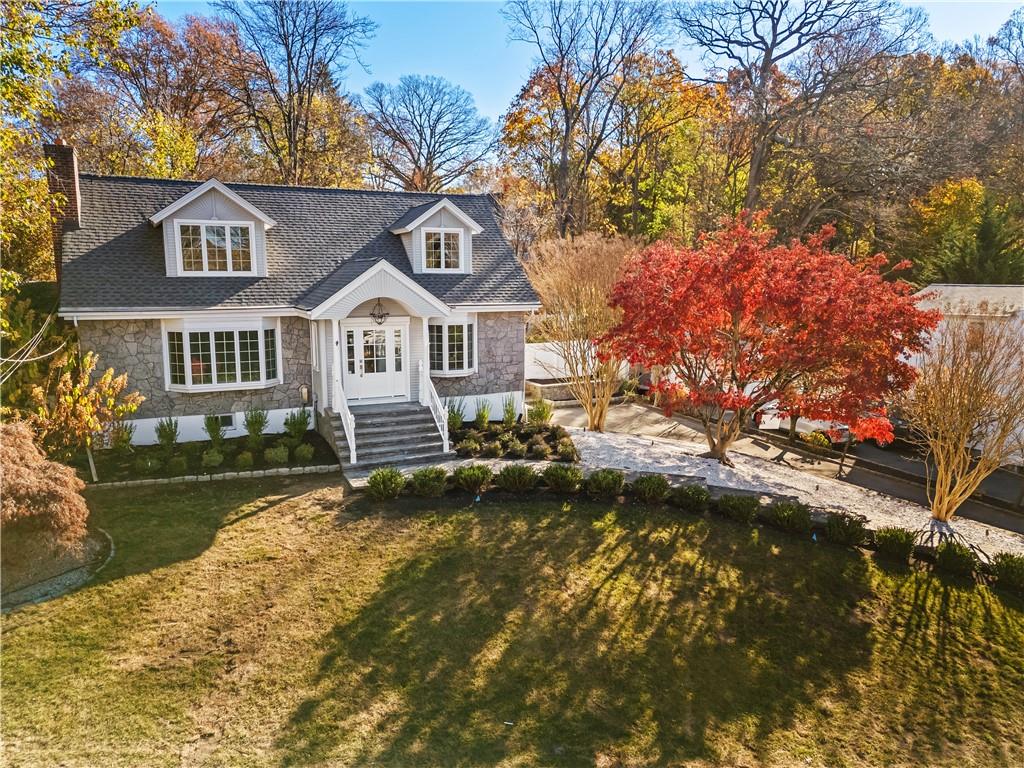 New England style home with a front lawn