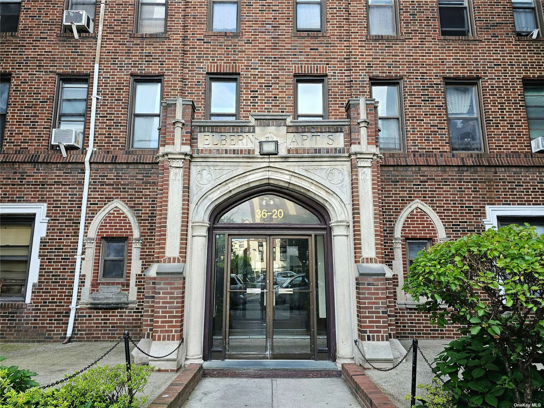 a view of a brick house with large windows