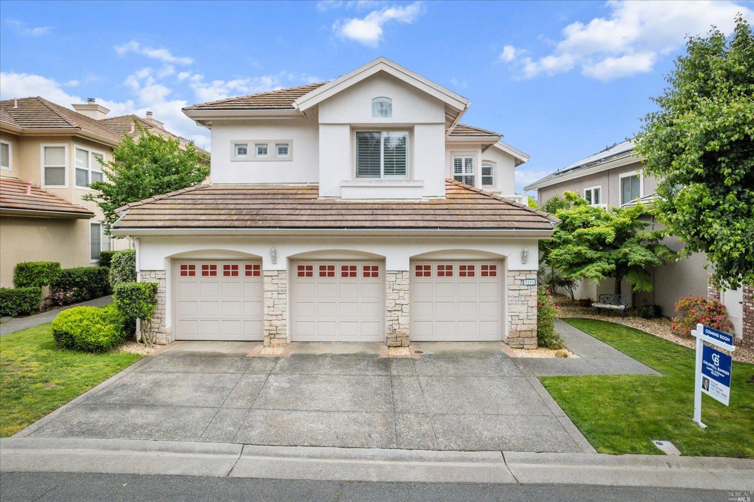 a view of a house with a yard and garage