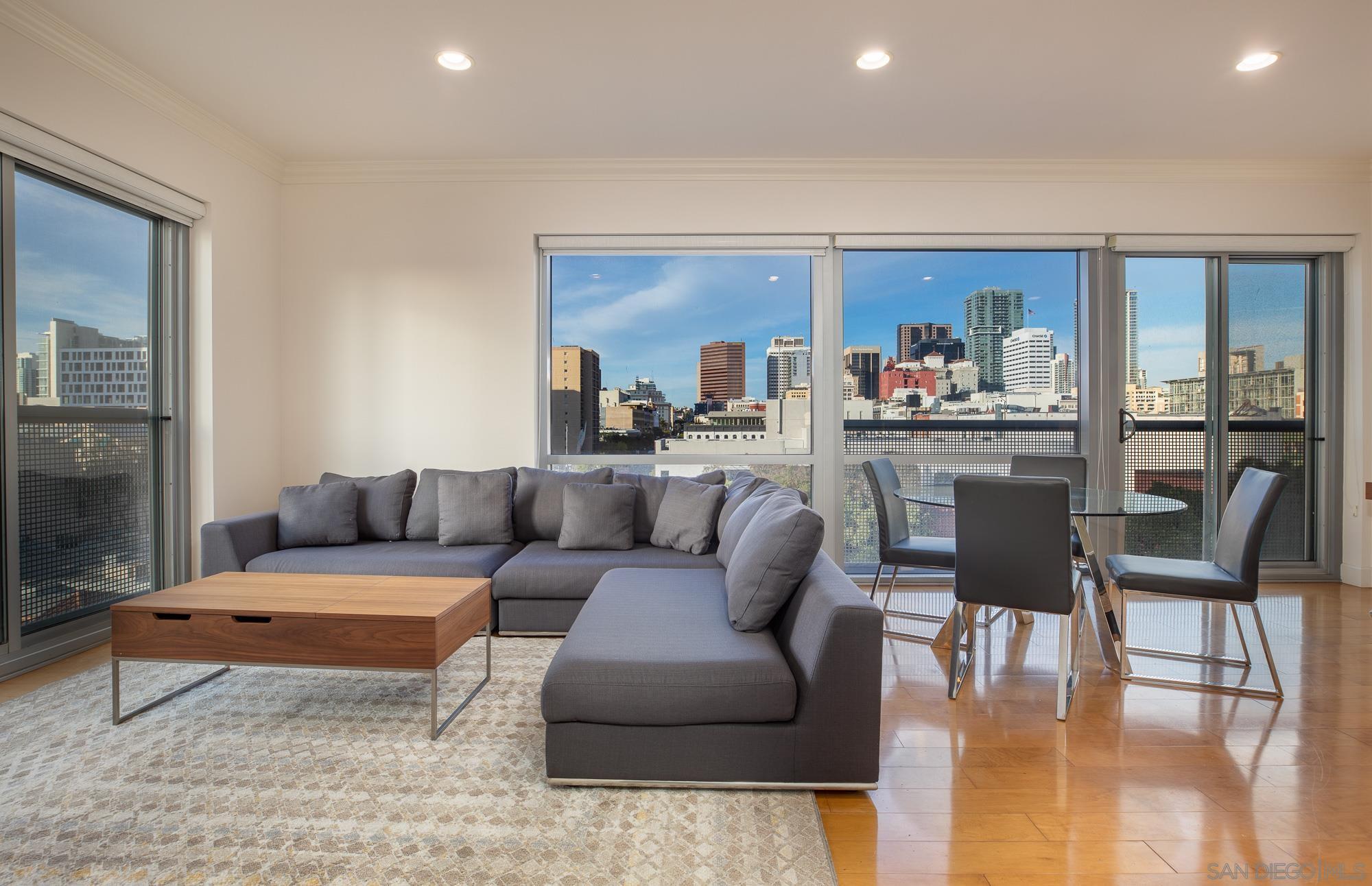 a living room with furniture and a painting on the wall