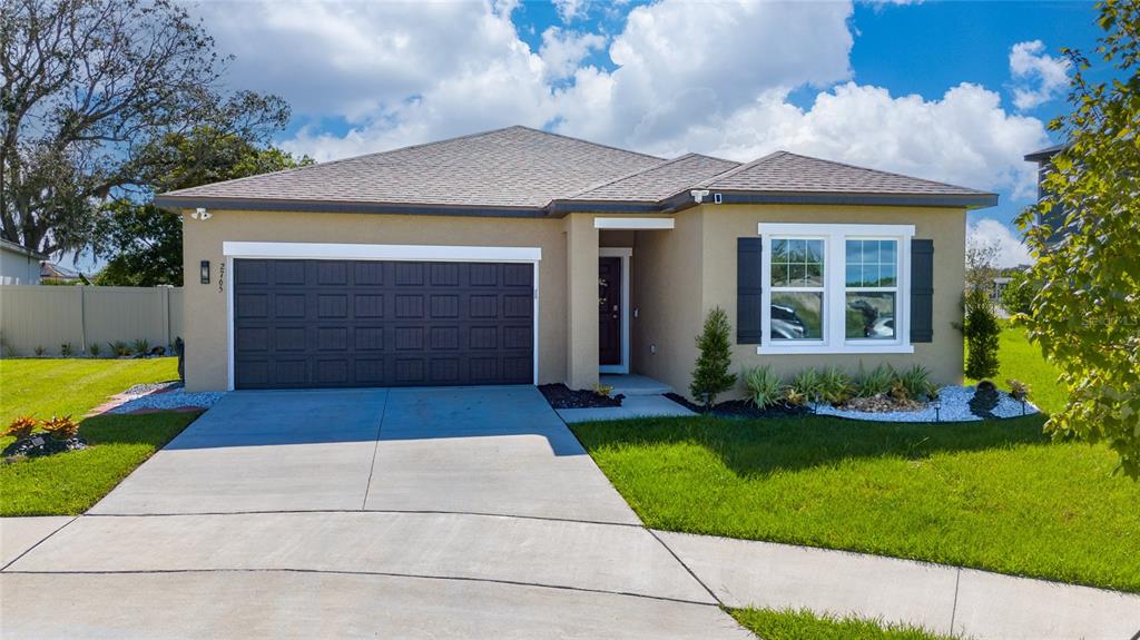 a front view of a house with a yard and garage