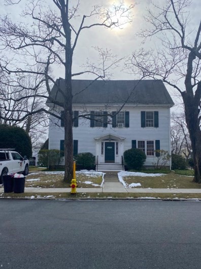 a house that has a tree in front of it