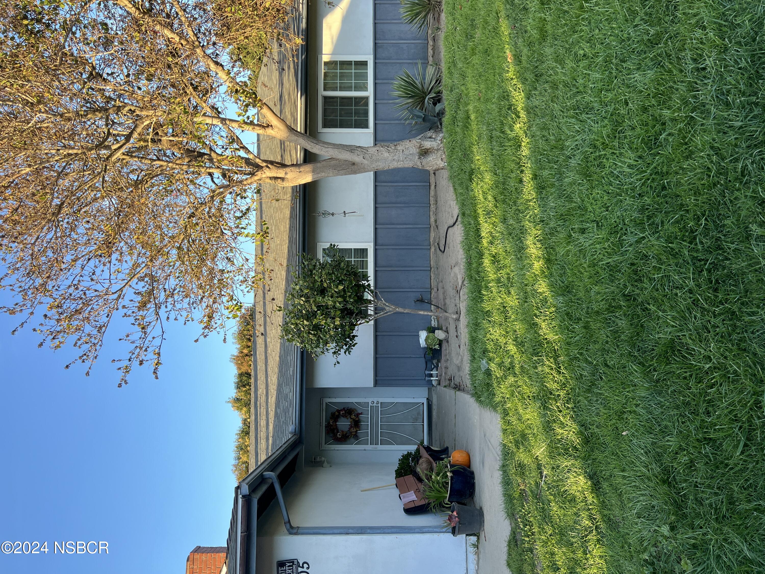 a view of a house with backyard and sitting area