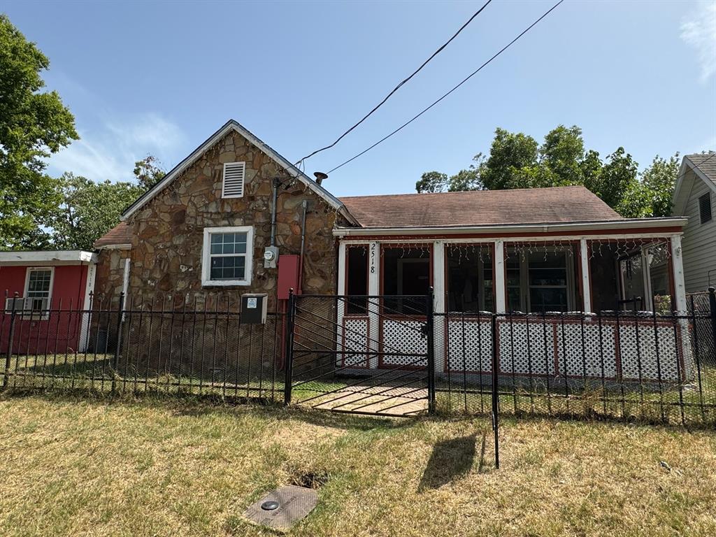 Rear view of property with a lawn