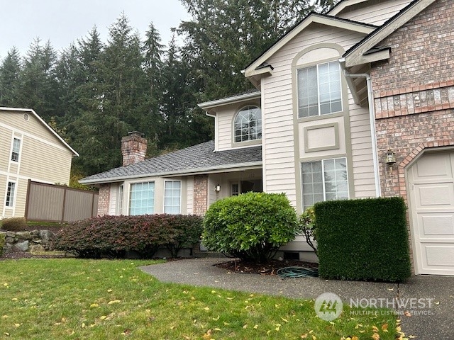 a view of a house with a yard and plants