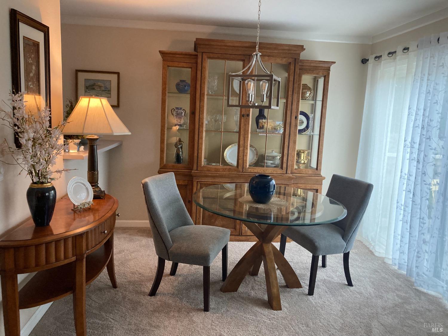 a view of a dining room with furniture and chandelier