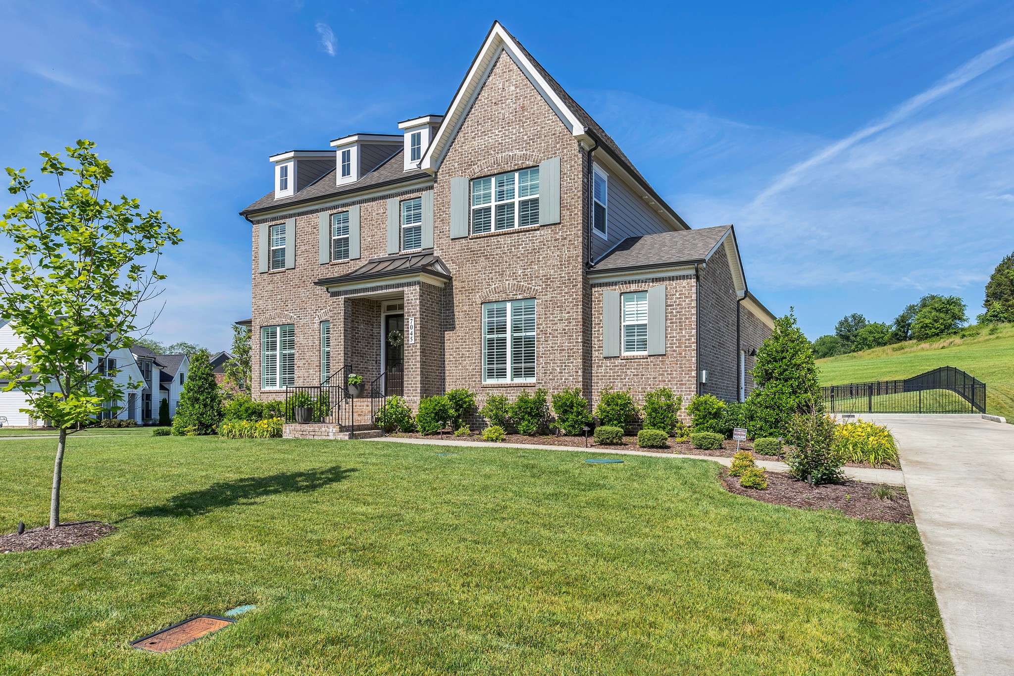 a front view of a house with a yard