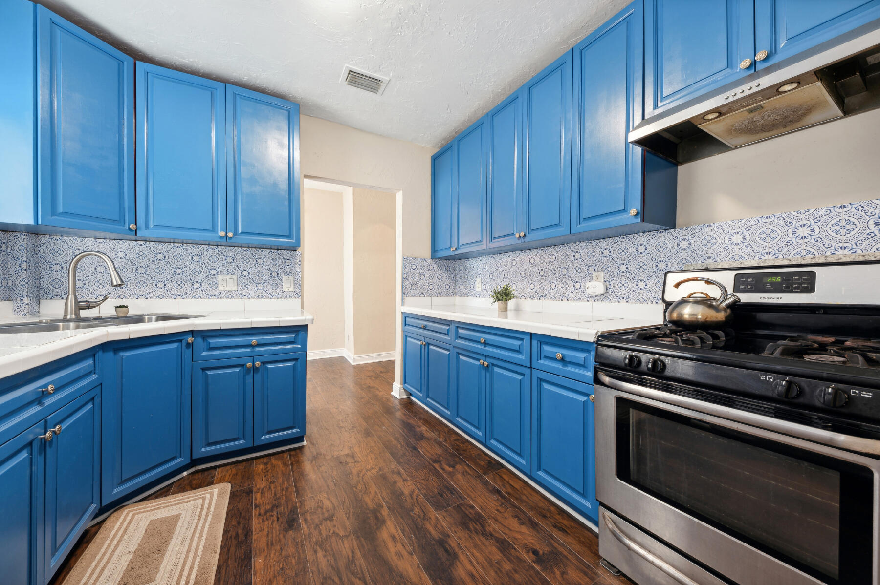 a kitchen with granite countertop wooden cabinets and stainless steel appliances