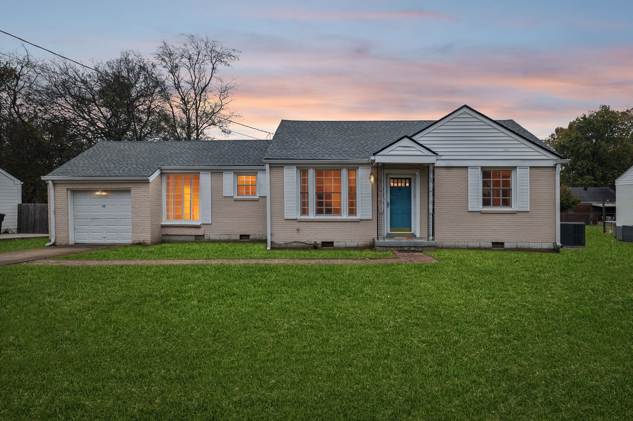 a front view of house with yard and green space