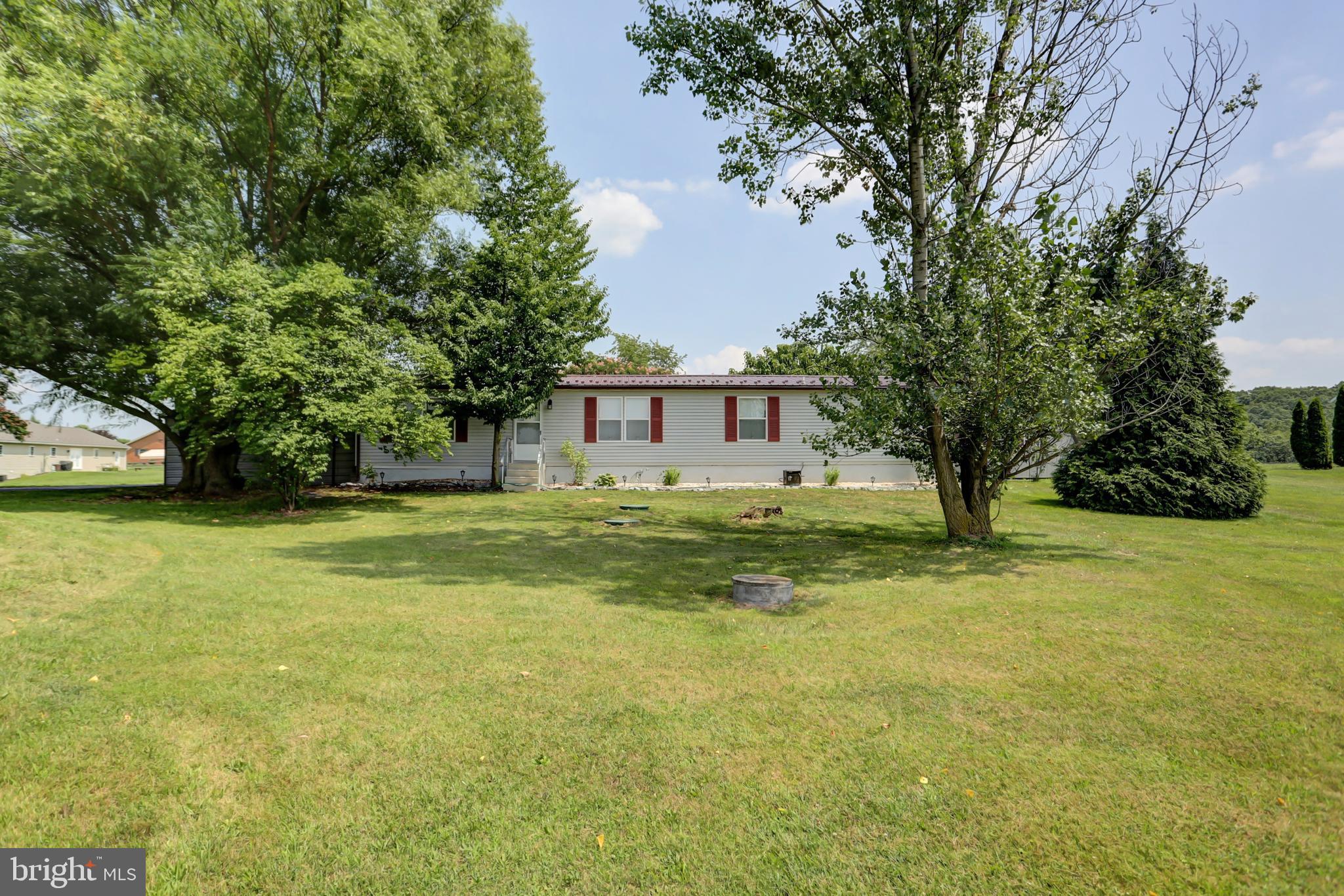 a front view of house with yard and trees