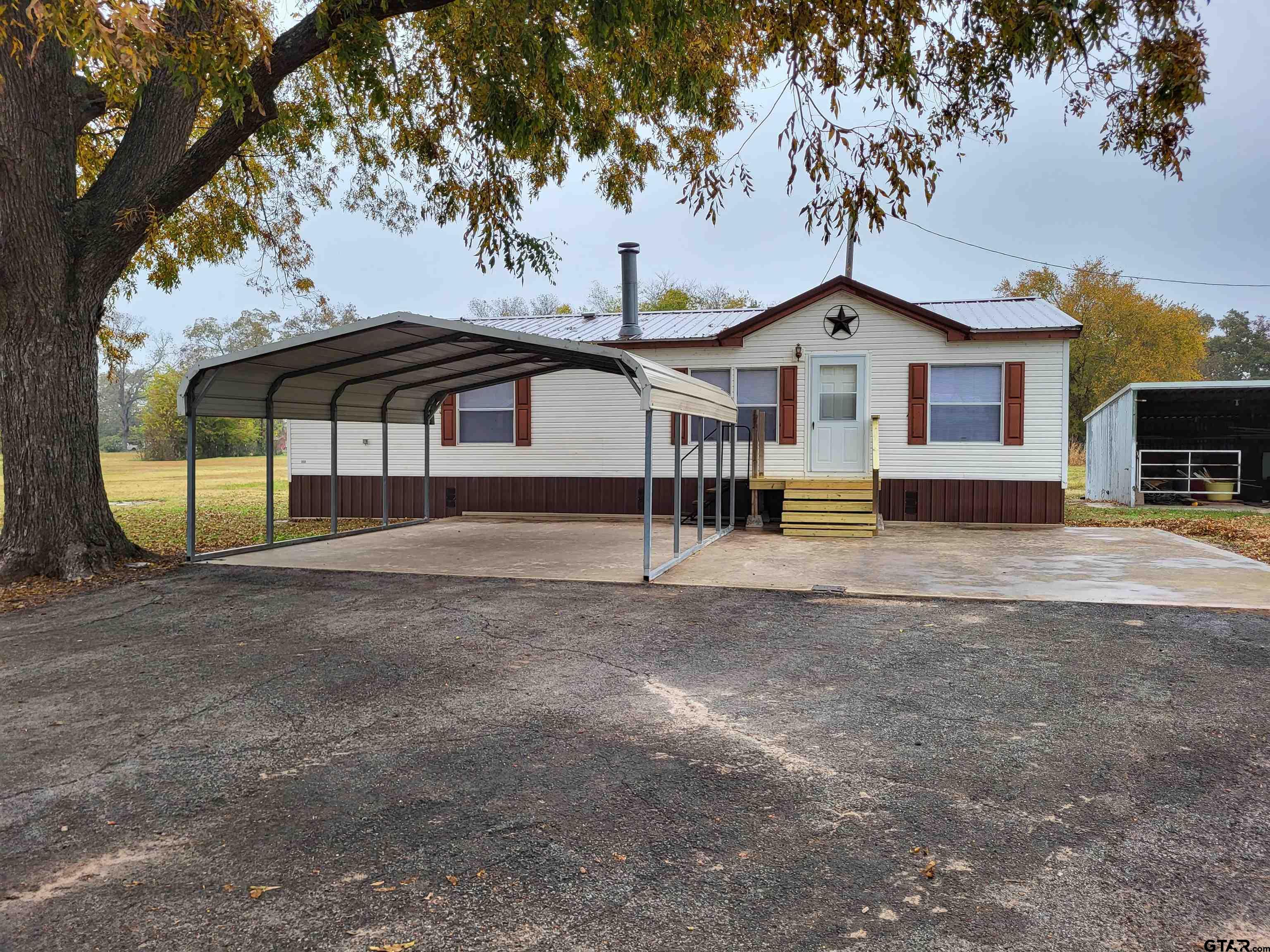 a view of a house with a yard and roof