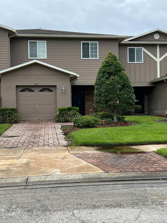 a front view of a house with a yard and garage