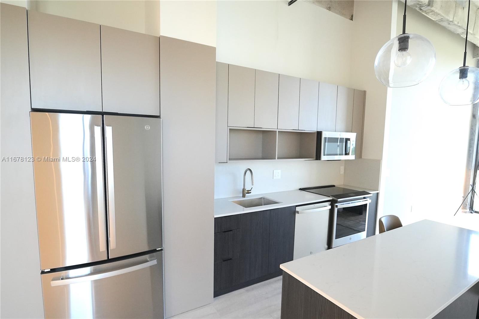 a kitchen with stainless steel appliances a refrigerator and a sink