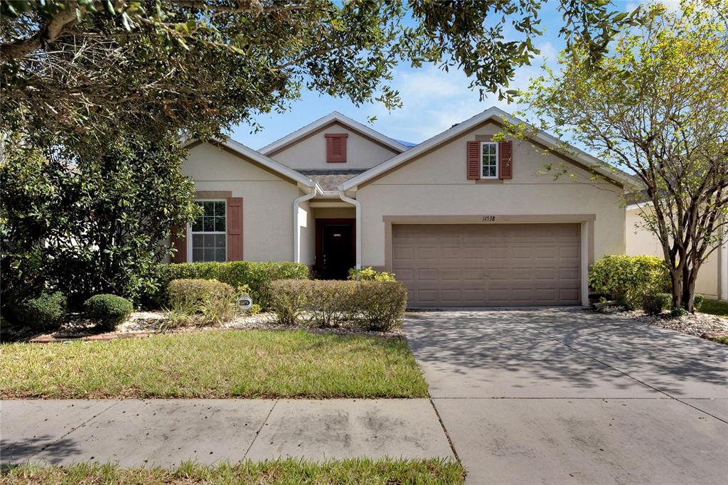 a front view of a house with a yard and garage