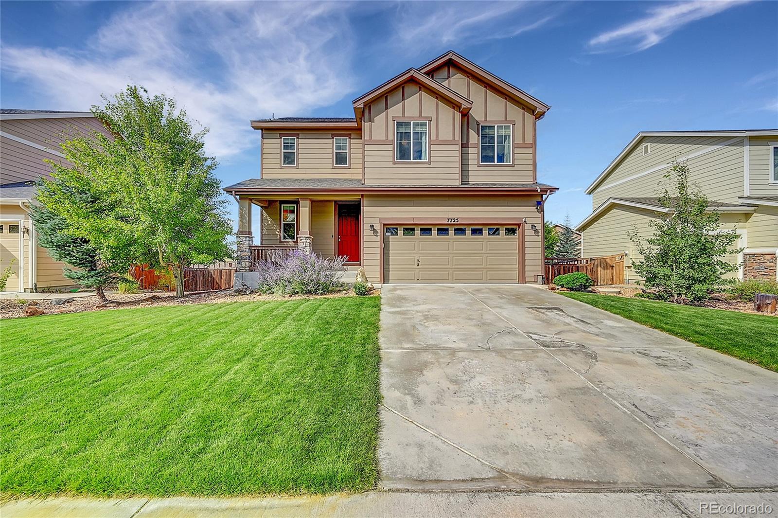 a front view of house with yard and green space