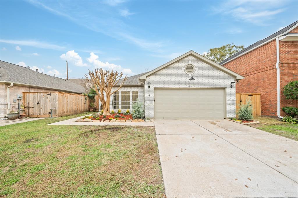 a view of a house with a yard and garage